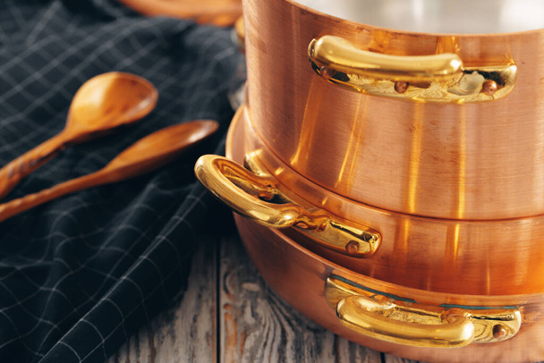 New copper cookware for professional kitchen close up - Foto, imagen
