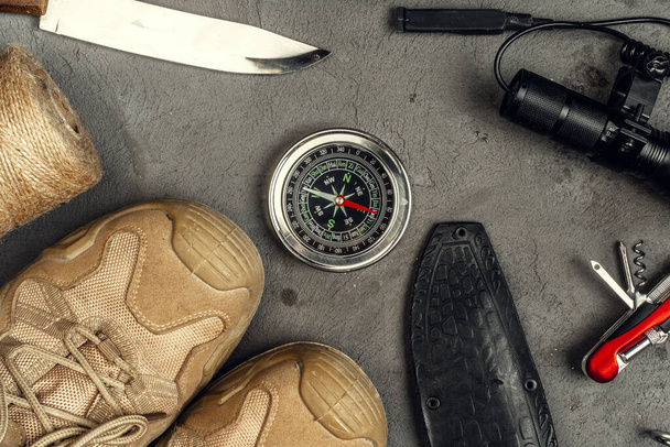Hiking boots, compass and knife. Hiking outdoor equipment - Fotó, kép