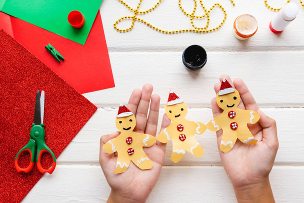 Application for kids. Christmas or New year card with gingerbread man from paper. DIY. - Φωτογραφία, εικόνα