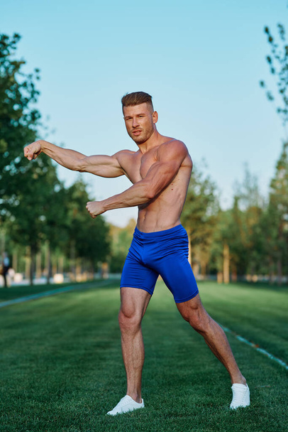 man doing exercises in the park inflated body - Foto, afbeelding