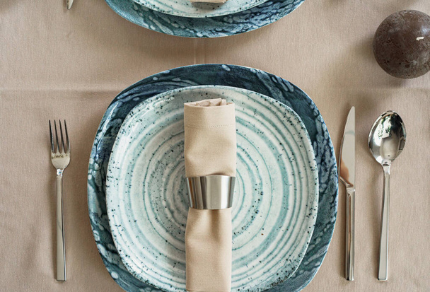 Details of a stylish table setting with textured ceramic dishes - Photo, Image