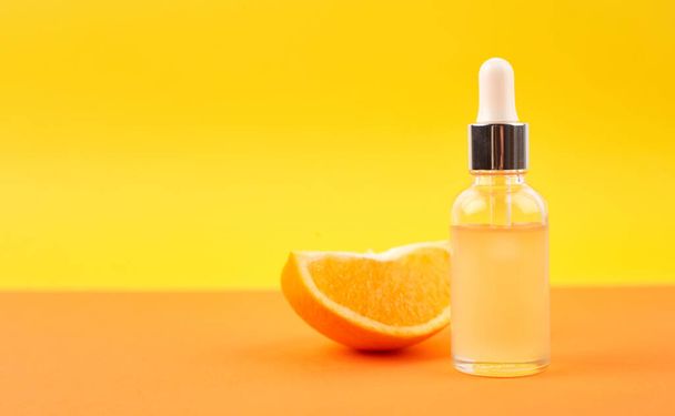 Pipette with orange essential oil over bottle and oranges. Natural medicine concept. Aromatherapy - Foto, Bild