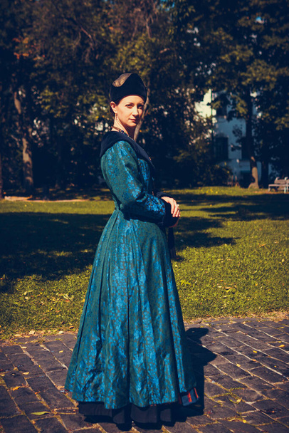 Portrait of woman dressed in blue historical Baroque clothes with old fashion hairstyle, outdoors. Luxurious medieval dress - Foto, afbeelding
