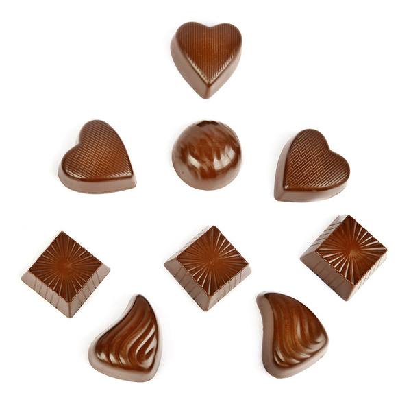 Various chocolate pralines isolated on white background. Top view. - Fotografie, Obrázek