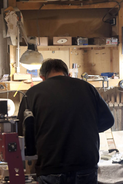 craftsman from behind working in the workshop - Photo, Image