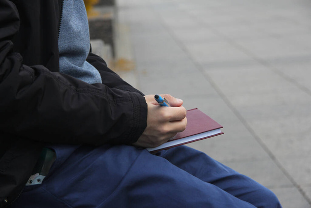 Young student with a diary in his hands  - Foto, Bild
