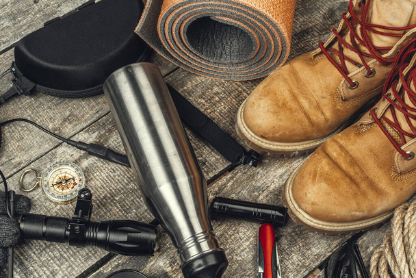 Hiking boots, compass and knife. Hiking outdoor equipment - Valokuva, kuva