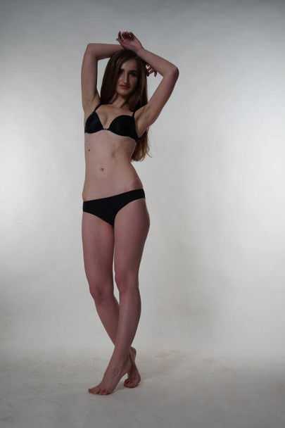 Sexy brunette woman posing in black bodysuit - Fotó, kép