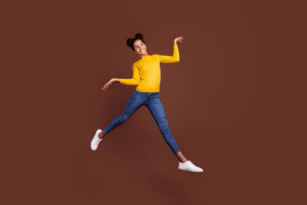 Full size photo of active preteen girl jump wear shirt jeans shoes isolated on brown color background - Φωτογραφία, εικόνα