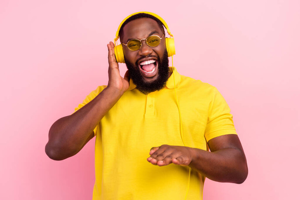 Photo of afro american happy crazy man wear headset dj music lover enjoy song isolated on pink color background - Fotografie, Obrázek