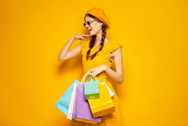 smiling woman with multicolored bags posing isolated background - Foto, afbeelding