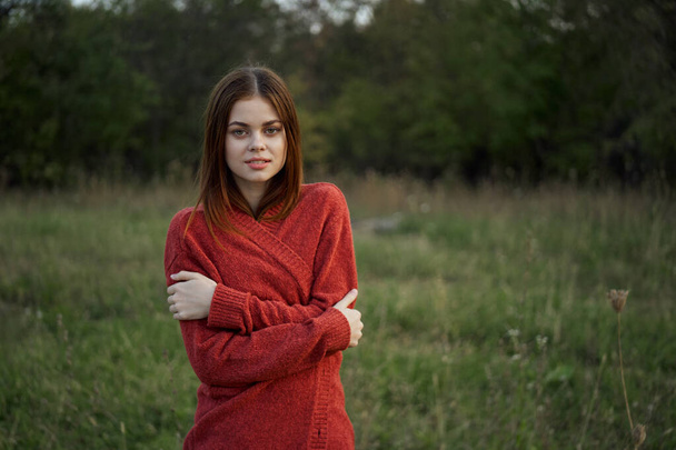 woman in a red sweater outdoors in the field nature rest - Φωτογραφία, εικόνα