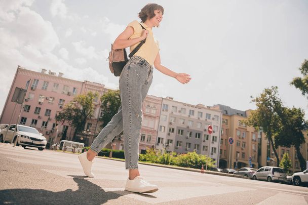 Full body photo of nice millennial brunette lady go wear t-shirt jeans footwear outside in park - Valokuva, kuva