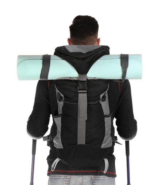 Male hiker with backpack and trekking poles on white background, back view - Фото, изображение
