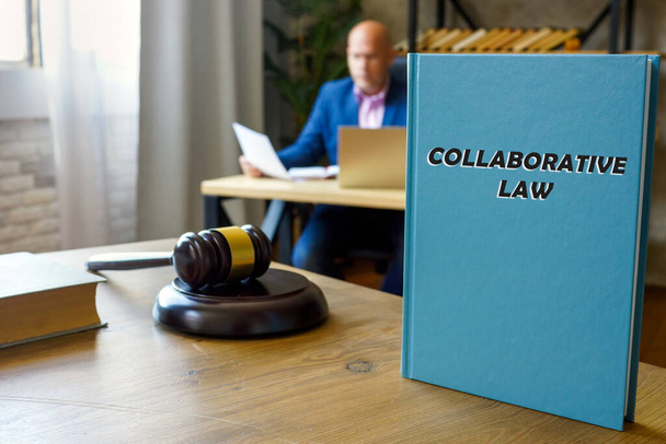  COLLABORATIVE LAW book in the hands of a attorney. Collaborative law, also known as collaborative practice, divorce or family law, is a legal process enabling couple - Foto, Imagen