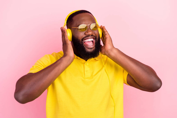 Photo of afro american cheerful crazy man enjoy music playlist cool mood isolated on pink color background - Foto, immagini