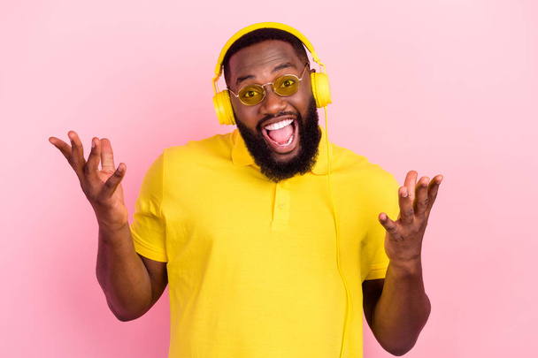 Photo of afro american amazed happy man listen music headphones cool isolated on pink color background - Foto, immagini