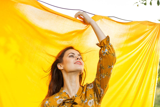 cheerful woman gesturing with her hands yellow background - Photo, Image