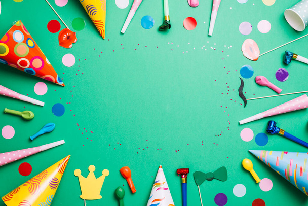 colorful birthday frame multicolor party items green background. High quality photo - 写真・画像