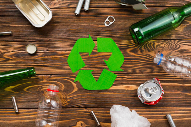 various reusable trash around recycling symbol. High quality photo - Zdjęcie, obraz