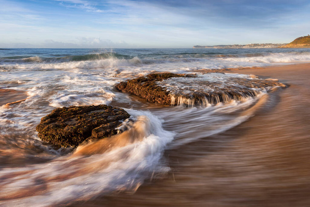 waves circling around rocks at forresters beach on nsw central coast - Photo, Image