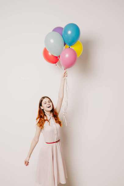 cheerful woman in a dress of colorful balloons - Foto, afbeelding