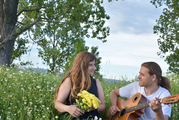 a woman and a man with a guitar, - Fotoğraf, Görsel