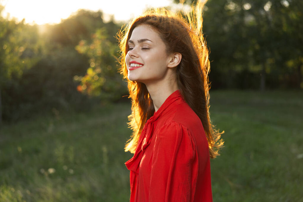 woman in red dress posing nature sun fun - Фото, изображение