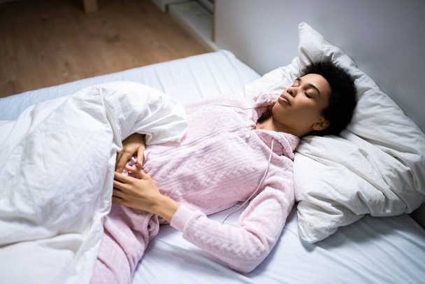 African American Woman With Stomach Pain Sleeping - Fotó, kép