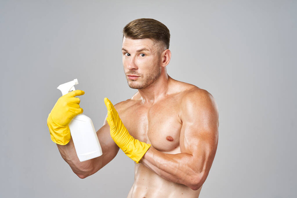 man with pumped muscles detergent posing cleaning - Фото, изображение