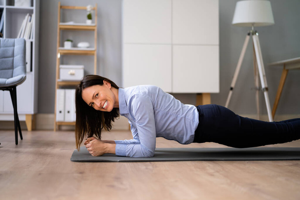 Woman Doing Office Plank Exercise Workout Training - Fotografie, Obrázek