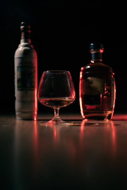 glass with cognac on a dark background - Photo, image