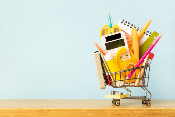 Stationery and office supplies in a miniature shopping cart. Back to school - Foto, immagini
