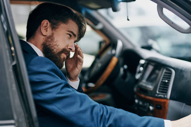 a man in a suit  in a car. High quality photo - Photo, Image