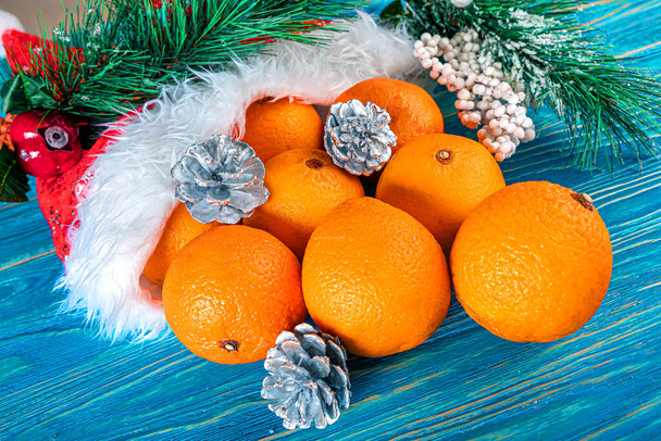 New Years mood. Oranges with Christmas tree branches and Christmas decorations - Фото, зображення