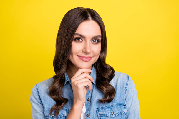 Photo of shiny thoughtful young woman dressed denim shirt arm chin smiling isolated yellow color background - Φωτογραφία, εικόνα