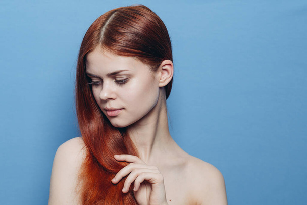 woman with bare shoulders red hair Glamor blue background - Fotografie, Obrázek