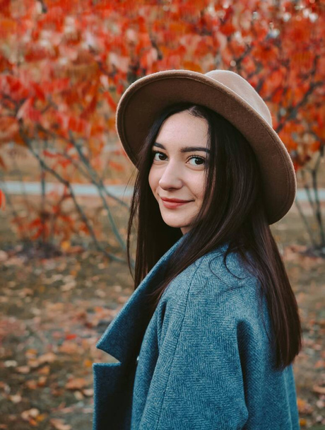 Portrait of young beautiful woman in brown hat  - Photo, Image