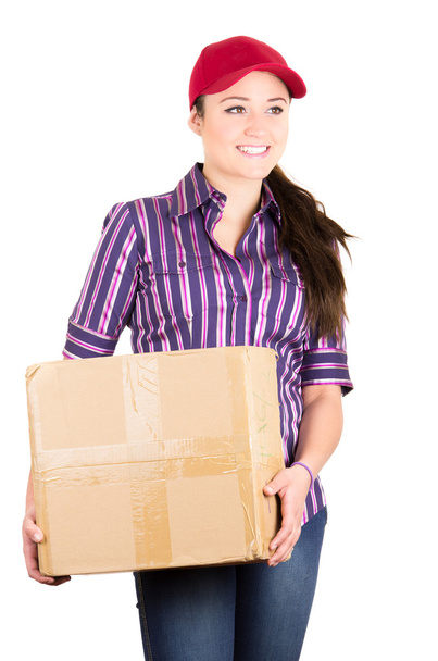 Young happy beautiful delivery girl carrying cardboard box - Photo, image