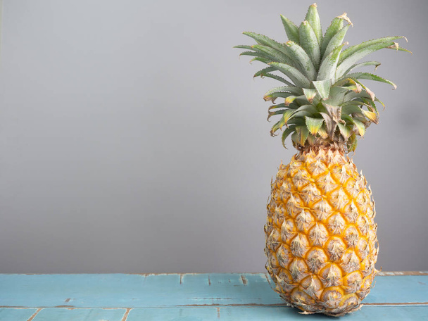 Ripe pineapple on a wooden table , healthy food. - Photo, Image