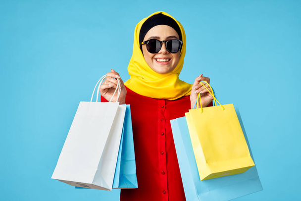 muslim woman in hijab shopping entertainment blue background - Photo, Image