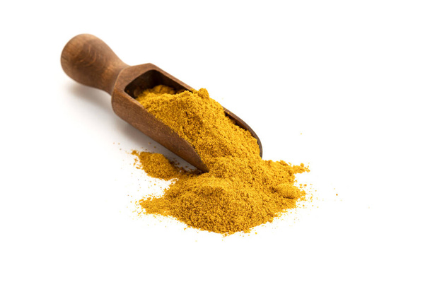 Curry powder in wooden scoop isolated on white background. Copy space - Fotografie, Obrázek
