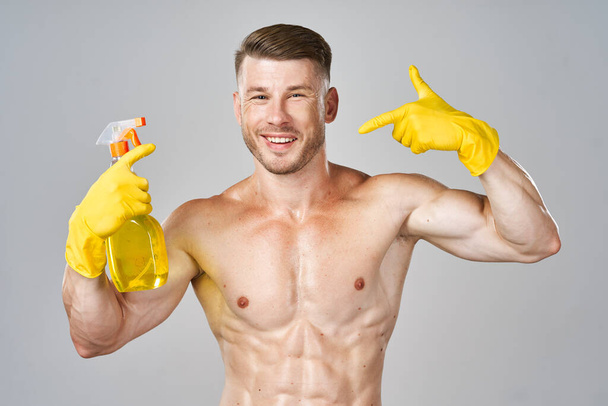 funny pumped up man rubber gloves detergents service - Foto, immagini