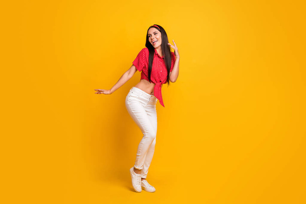 Full length photo of cute adorable young girl dressed red shirt dancing isolated yellow color background - Φωτογραφία, εικόνα