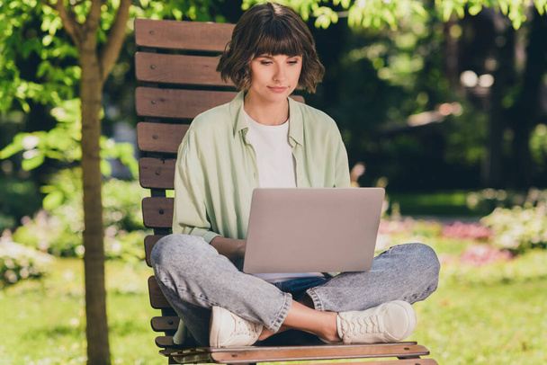 Full length body size photo smiling young girl sitting on bench with laptop doing project - Foto, immagini