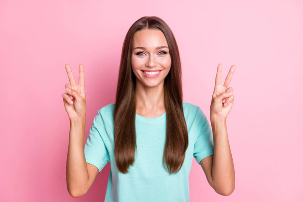 Photo portrait of female student staring showing v-sign with both hands smiling isolated on pastel pink color background - Foto, imagen