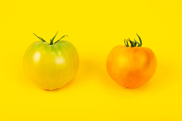 Mix of ripe colorful tomatoes on bright yellow background. Studio Photo. - Fotoğraf, Görsel