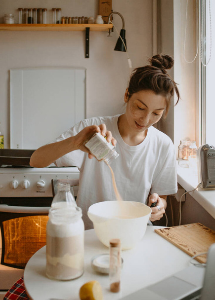 nainen ruoanlaitto pyjamassa keittiössä aamulla - Valokuva, kuva