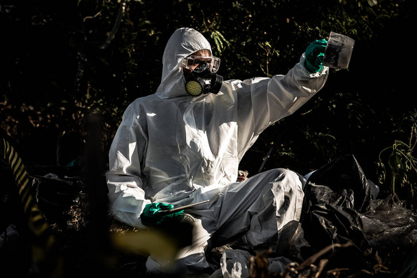 Asian scientist wearing Chemical protection suit working at dangerous zone collecting samples in case of Corona virus investigation outbreak from China. - Fotoğraf, Görsel