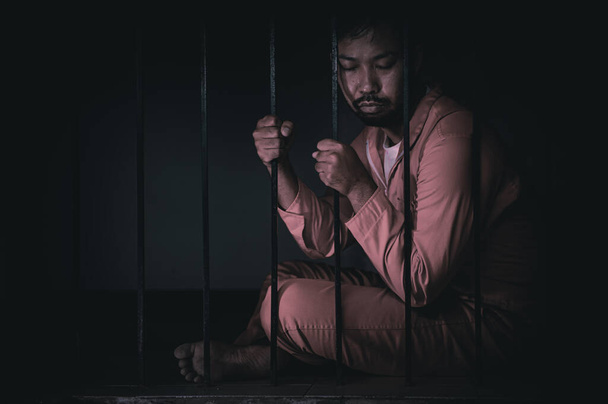 Portrait of man desperate to catch iron prison, prisoner concept - Zdjęcie, obraz
